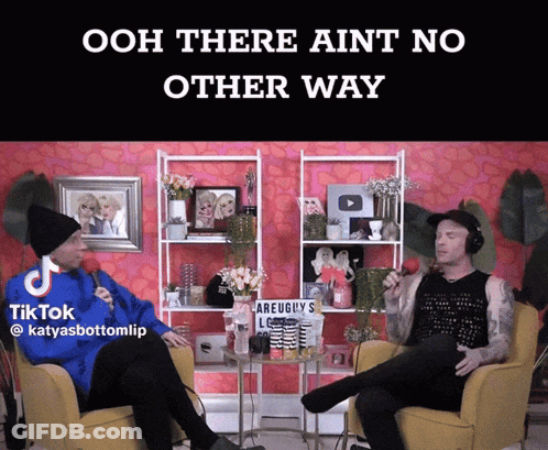 Two Men Sitting In Chairs In Front Of Pink TikTok Sign GIF