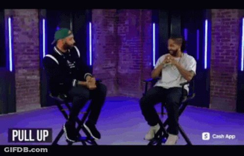 Two Men Sitting In Chairs GIF