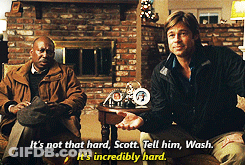 Two Men Sitting In Front Of A Fireplace With One Saying It 'S Not That Hard Scott Tell Him Wash GIF