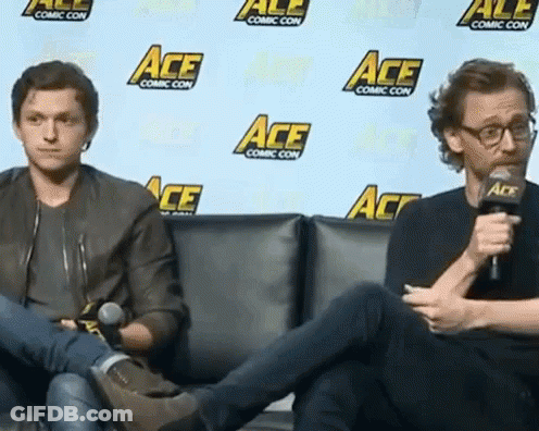 Two Men Sitting In Front Of Ace Wall GIF