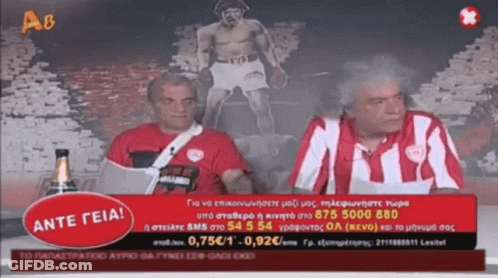 Two Men Sitting In Front Of Ante Geia Sign GIF