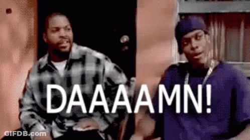 Two Men Sitting In Front Of Building Saying Daaaamm GIF