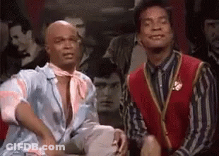 Two Men Sitting In Front Of Crowd GIF