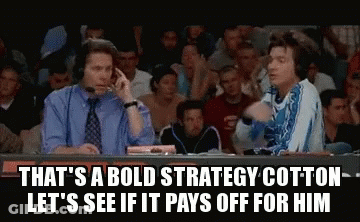 Two Men Sitting In Front Of Crowd One Talking On Phone GIF