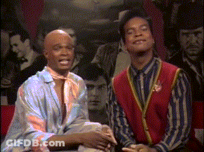 Two Men Sitting In Front Of Crowd GIF