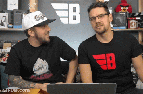 Two Men Sitting In Front Of EB Sign GIF