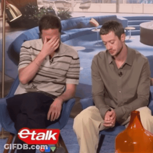 Two Men Sitting In Front Of Etalk Sign GIF