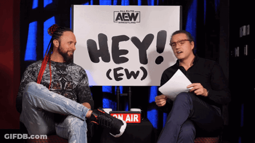 Two Men Sitting In Front Of Hey (Ew) Sign GIF