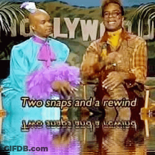 Two Men Sitting In Front Of Hollywood Sign GIF