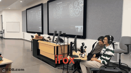 Two Men Sitting In Front Of IFox Screen GIF