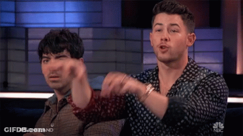 Two Men Sitting In Front Of Songland Screen GIF