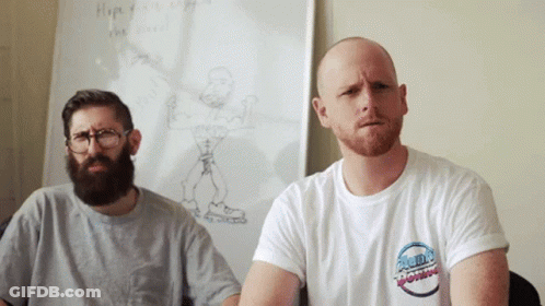 Two Men Sitting In Front Of White Board With Drawing GIF
