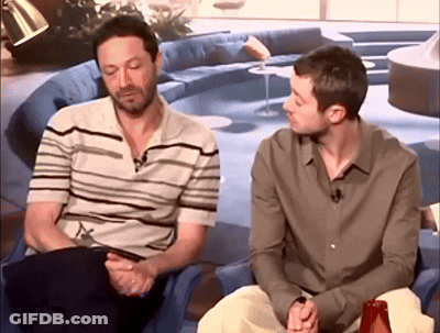Two Men Sitting In Living Room Talking GIF