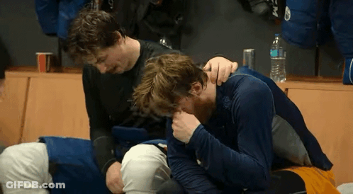 Two Men Sitting In Locker Room GIF
