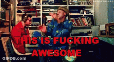 Two Men Sitting In Room Saying This Is Fucking Awesome GIF