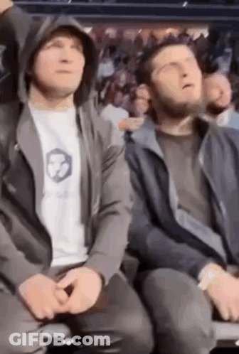 Two Men Sitting In Stadium Watching Boxing Match GIF