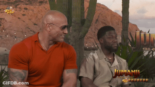 Two Men Sitting Near Jumanji Poster GIF