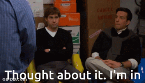 Two Men Sitting Near Moving Boxes And Sign GIF