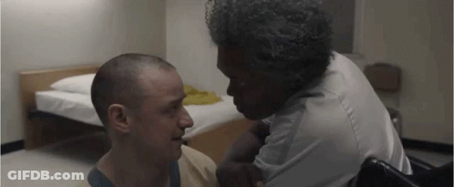 Two Men Sitting Next To Bed GIF