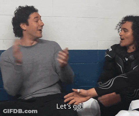 Two Men Sitting Next To Each Other GIF