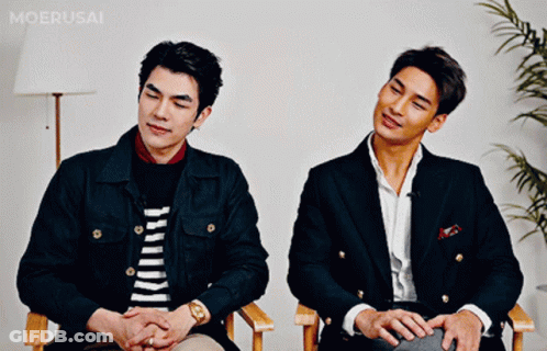 Two Men Sitting Next To Each Other GIF