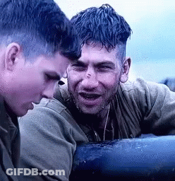 Two Men Sitting Next To Each Other On A Boat GIF