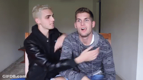 Two Men Sitting Next To Each Other One Wearing Abercrombie & Fitch Sweater GIF