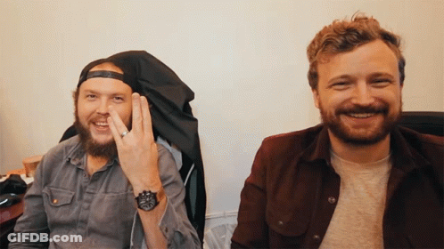 Two Men Sitting Next To Each Other One Wearing Watch GIF