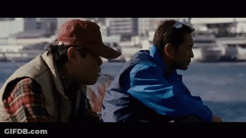 Two Men Sitting Next To Each Other GIF