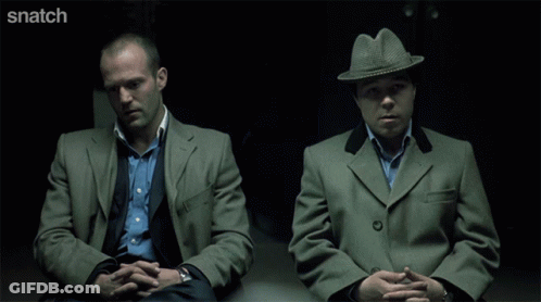 Two Men Sitting Next To Each Other With Snatch Written On The Bottom Right GIF