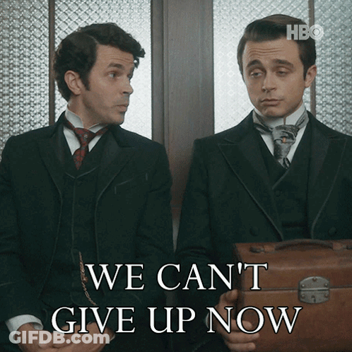 Two Men Sitting Next To Each Other With The Words We Can 'T Give Up Now Behind Them GIF