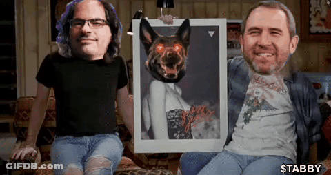 Two Men Sitting On A Couch Holding A Picture Of A Dog With Red Eyes GIF