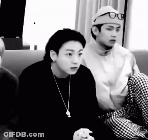 Two Men Sitting On A Couch One Wearing Hat And Glasses GIF