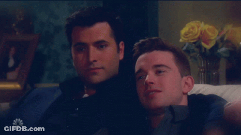 Two Men Sitting On A Couch With A Nbc Logo On The Bottom Right GIF