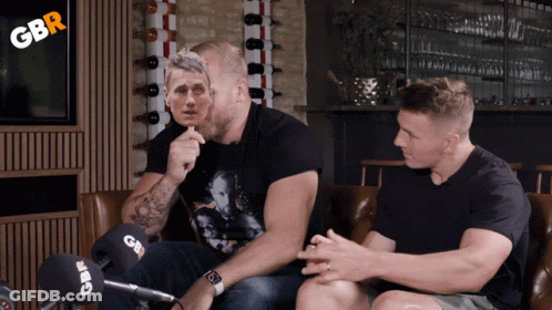Two Men Sitting On A Couch With Gbr Written On The Corner GIF