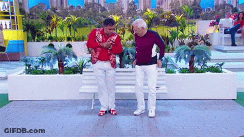 Two Men Sitting On Bench In Garden GIF