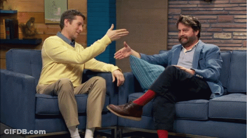 Two Men Sitting On Blue Couch Talking GIF