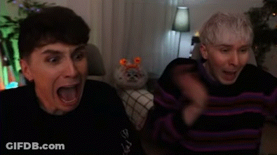 Two Men Sitting On Couch Laughing GIF