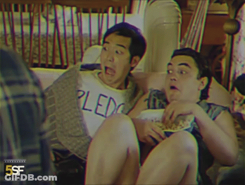 Two Men Sitting On Couch One In Pledge Shirt GIF