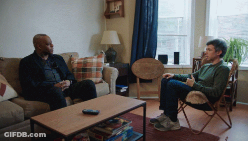 Two Men Sitting On Couch Talking GIF