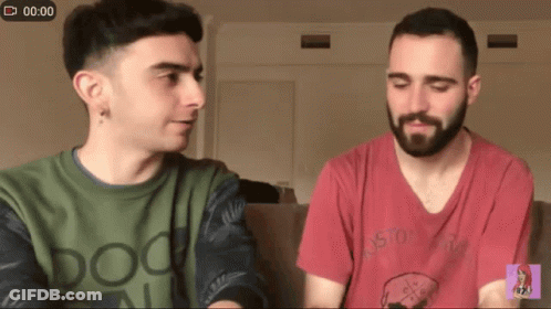 Two Men Sitting On Couch With Doo Shirt GIF