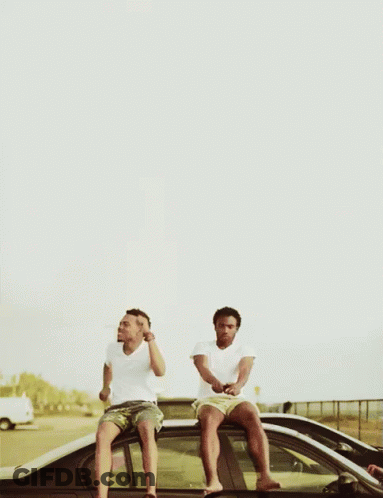 Two Men Sitting On The Roof Of A Car Drinking Beer GIF