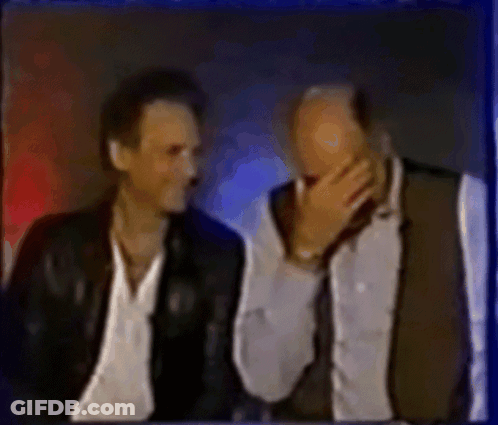 Two Men Sitting One Covering Mouth GIF