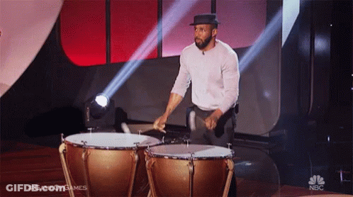 Two Men Sitting, One In Black Puma Shirt GIF