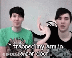 Two Men Sitting One Says I Trapped My Arm In A Car Door GIF