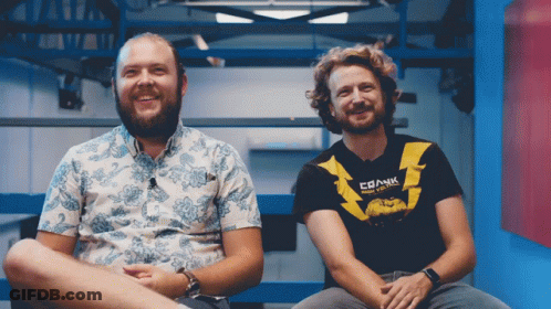 Two Men Sitting, One Shirt Says Crank GIF