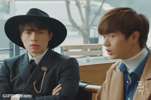 Two Men Sitting One Wearing Hat GIF
