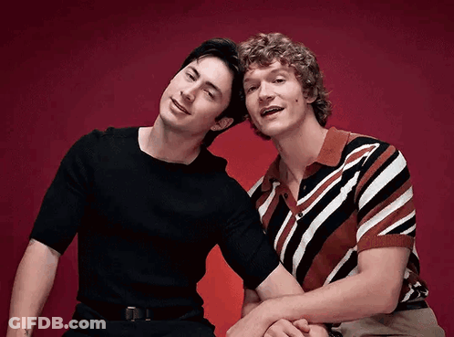 Two Men Sitting Side By Side GIF