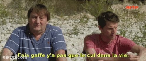 Two Men Sitting With Fais Gaffe Y'a Pas Que Le Cul Dans La Vie GIF