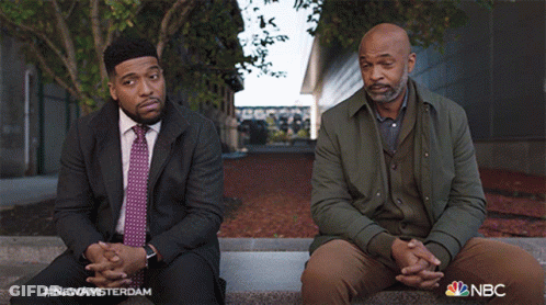 Two Men Sitting With NBC GIF
